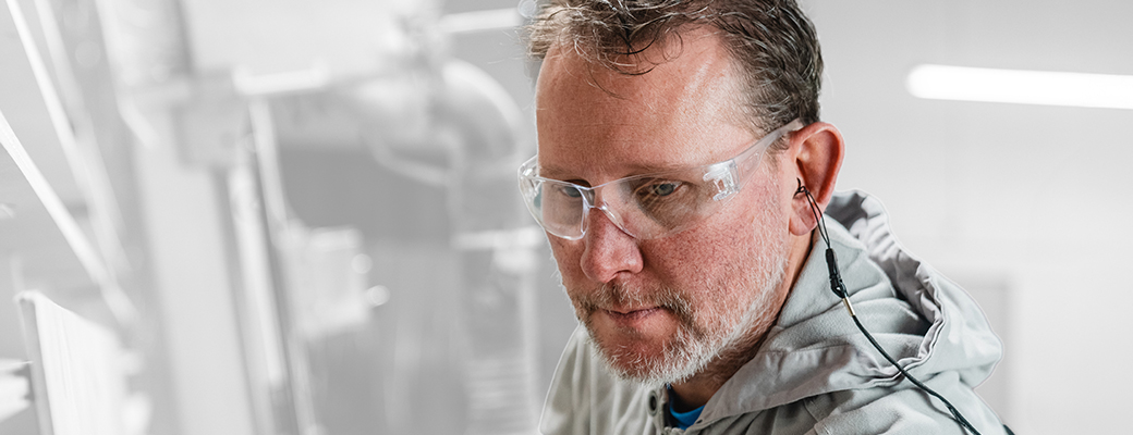 Image of man wearing protective goggles and hearing protection devices